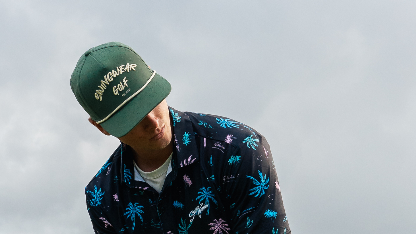 green golf hat and tropical golf polo