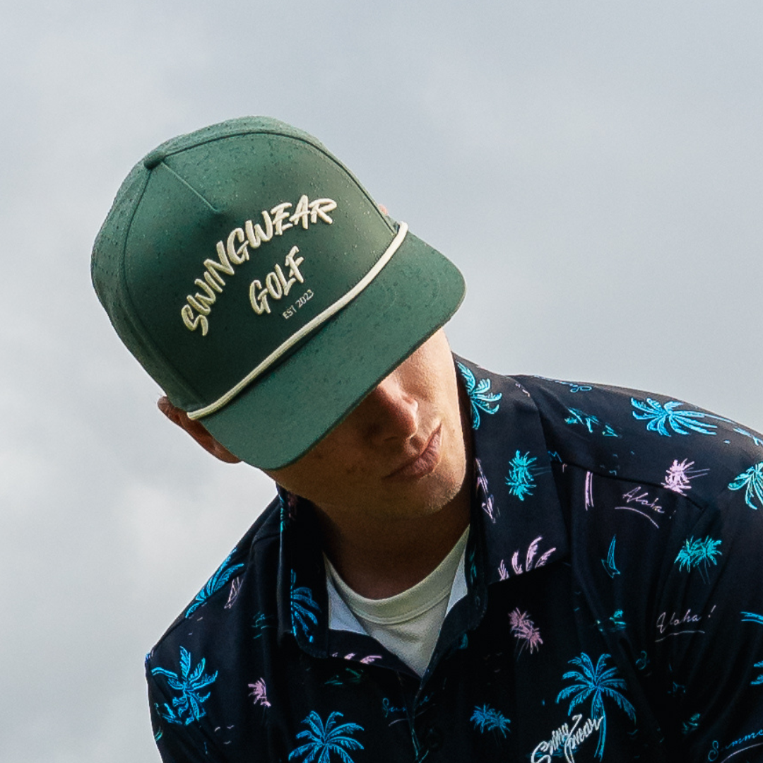 man playing golf with green hat