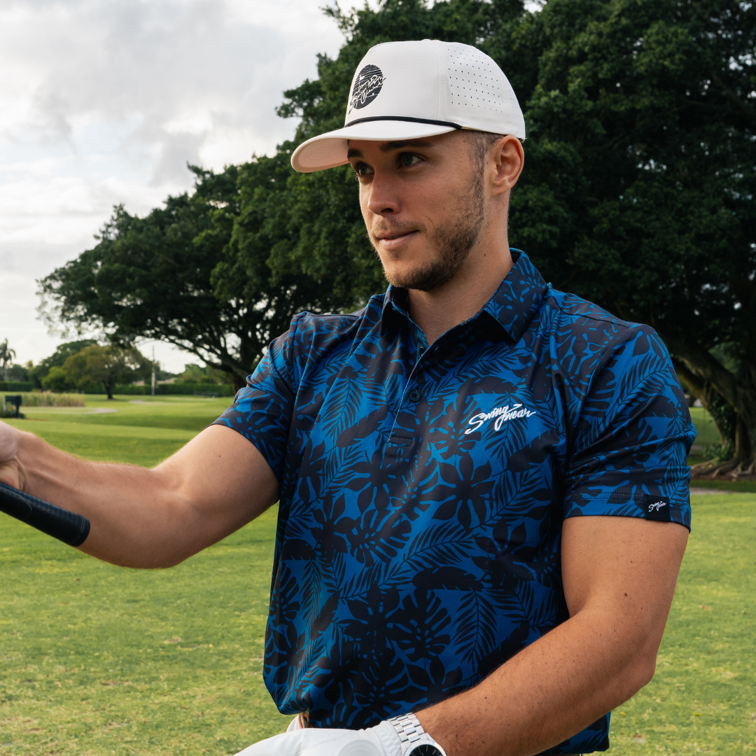 blue tropical golf polo and white hat