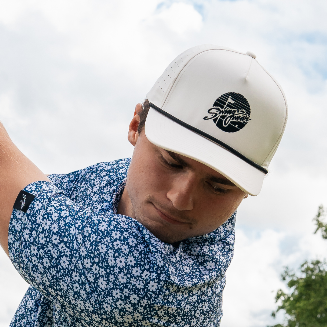 man wearing swingwear white golf hat